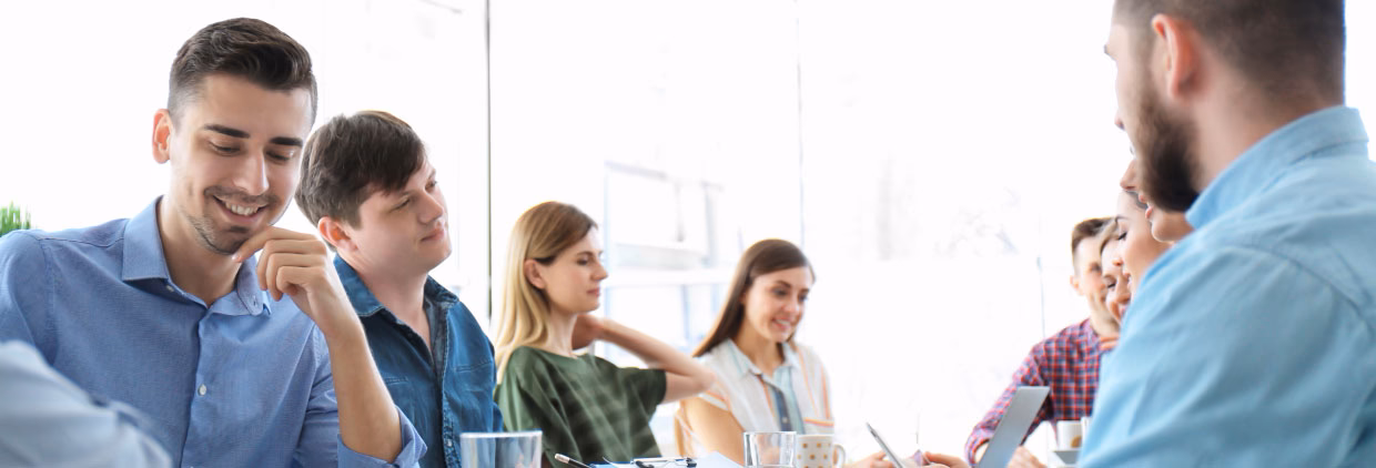 Business colleagues discussing ideas while seated at a conference table.
